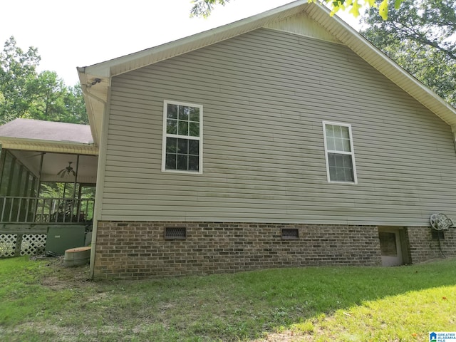 view of home's exterior featuring a yard and ceiling fan