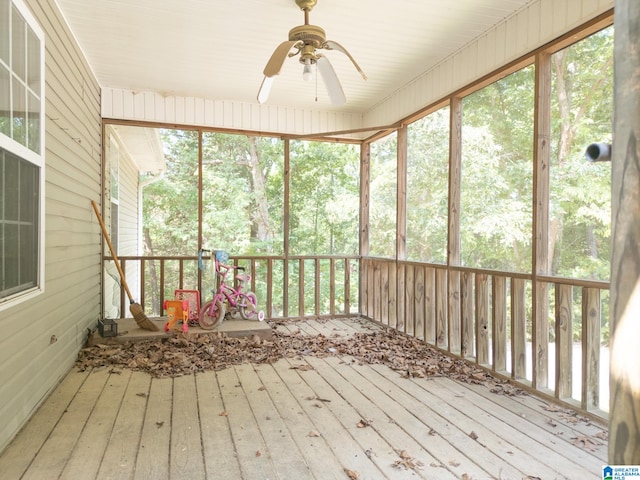 unfurnished sunroom featuring ceiling fan