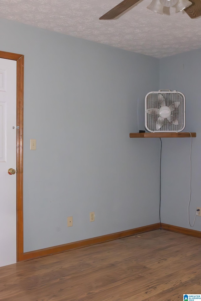 spare room featuring hardwood / wood-style floors, a textured ceiling, and ceiling fan