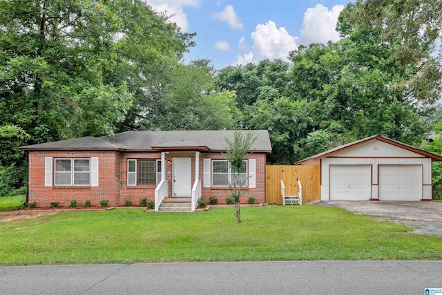 single story home featuring an outdoor structure, a front yard, and a garage