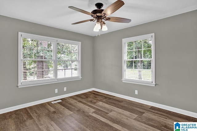 spare room with plenty of natural light, dark hardwood / wood-style flooring, and ceiling fan