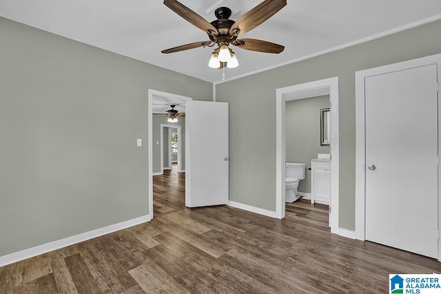 unfurnished bedroom featuring dark hardwood / wood-style flooring, ceiling fan, and ensuite bath