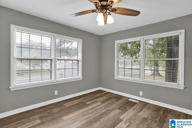 spare room with ceiling fan and dark hardwood / wood-style floors