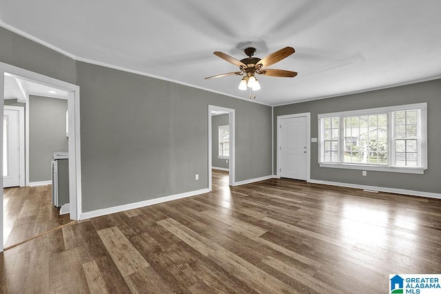 unfurnished room with dark hardwood / wood-style floors, ceiling fan, and ornamental molding