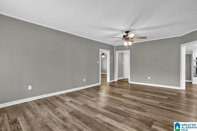 empty room with ceiling fan, dark hardwood / wood-style flooring, and crown molding