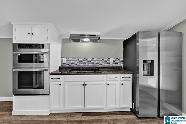 kitchen featuring white cabinets, dark hardwood / wood-style flooring, tasteful backsplash, and stainless steel appliances