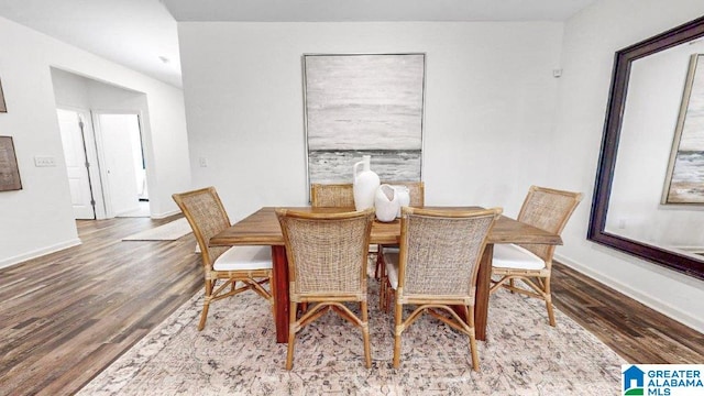 dining space with hardwood / wood-style flooring