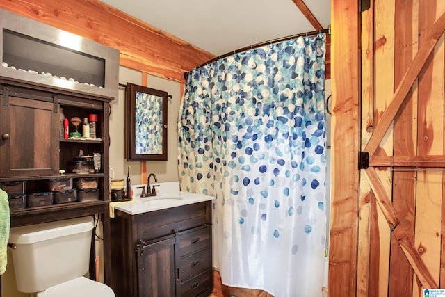 bathroom featuring oversized vanity and toilet