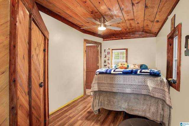 bedroom featuring wood-type flooring, vaulted ceiling, and wood ceiling