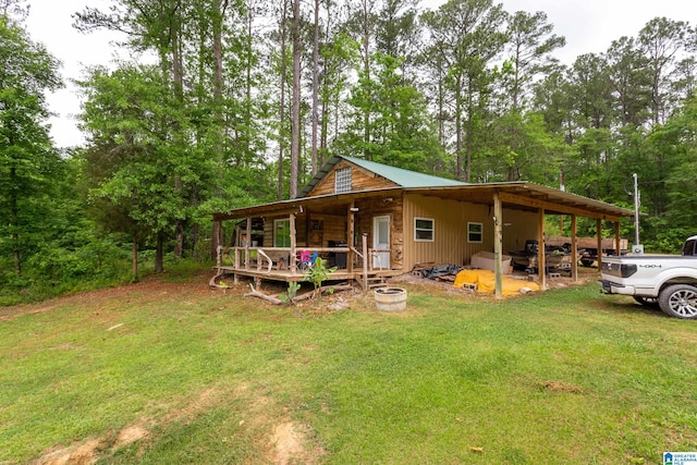 exterior space with a carport and a yard