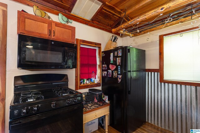 kitchen with wooden ceiling, hardwood / wood-style flooring, and black appliances