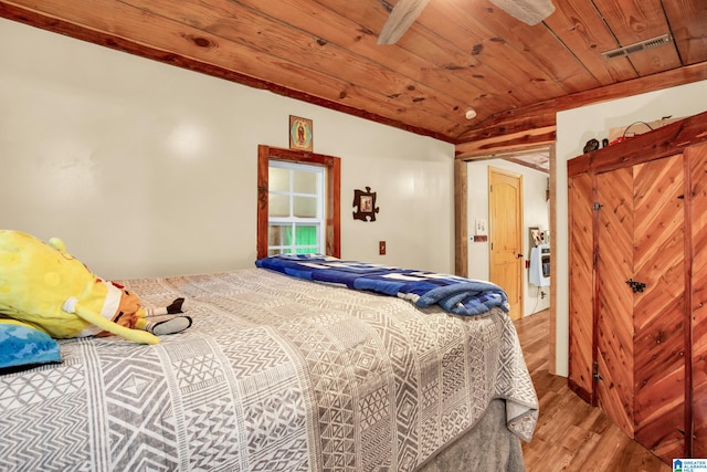 bedroom featuring hardwood / wood-style floors, wooden ceiling, and lofted ceiling