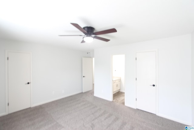 unfurnished bedroom with connected bathroom, ceiling fan, and carpet floors