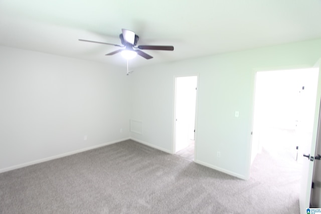 empty room featuring ceiling fan and carpet flooring