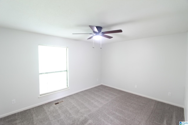 empty room featuring carpet floors and ceiling fan