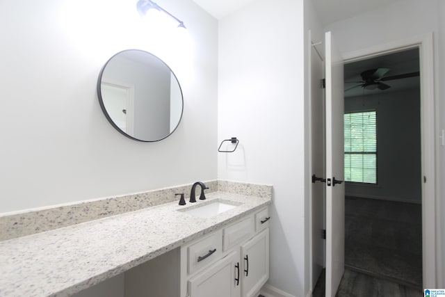 bathroom with hardwood / wood-style floors, ceiling fan, and large vanity