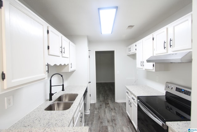 kitchen with stainless steel range with electric stovetop, white cabinetry, sink, and light wood-type flooring