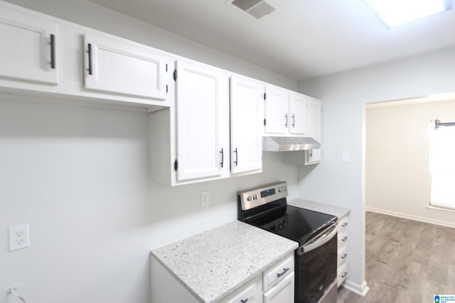 kitchen with hardwood / wood-style flooring, stainless steel range with electric stovetop, white cabinetry, and light stone countertops