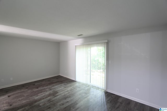 empty room with dark wood-type flooring