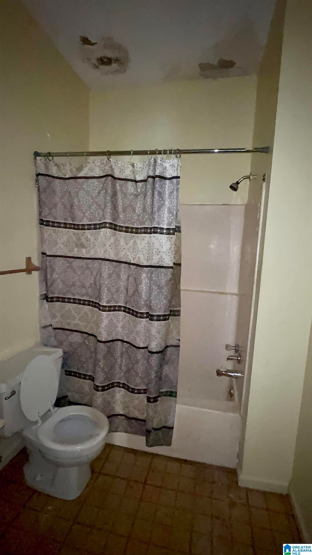 bathroom with toilet, tile flooring, and shower / bath combination with curtain