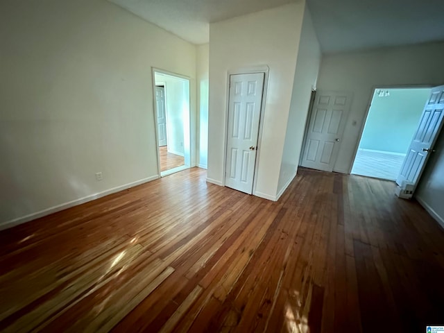 unfurnished bedroom featuring dark hardwood / wood-style flooring