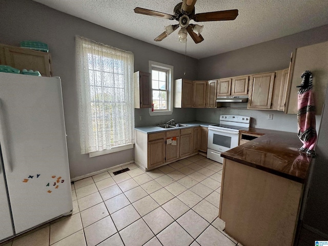 kitchen with white appliances, ceiling fan, a textured ceiling, sink, and light tile floors