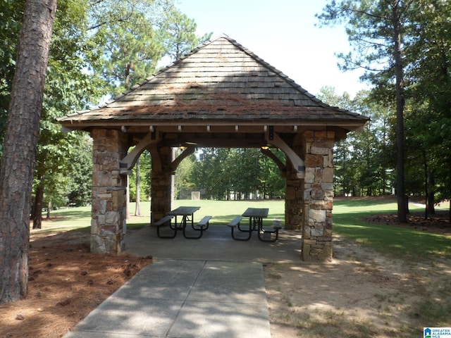 view of property's community with a gazebo, a patio area, and a lawn