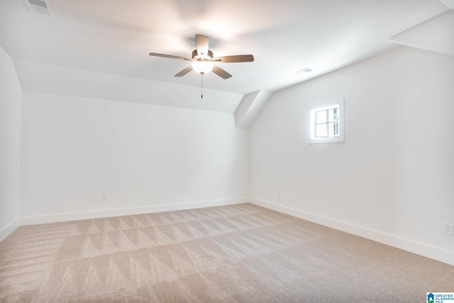 bonus room featuring ceiling fan, vaulted ceiling, and light carpet