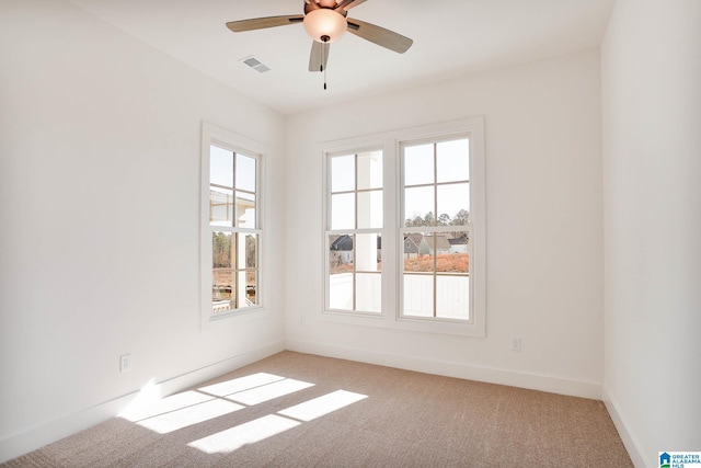 empty room with light carpet and ceiling fan