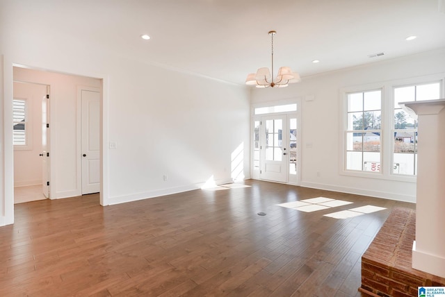 interior space with ornamental molding, dark hardwood / wood-style floors, and a chandelier