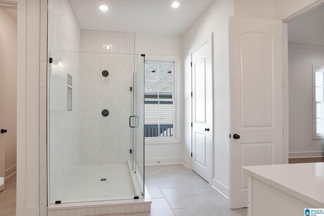 bathroom featuring recessed lighting, a shower stall, tile patterned floors, a wealth of natural light, and baseboards