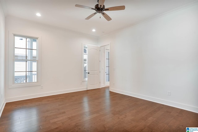 empty room featuring baseboards, a ceiling fan, dark wood-style floors, and crown molding
