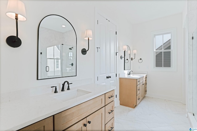 full bathroom with marble finish floor, two vanities, a sink, and a stall shower