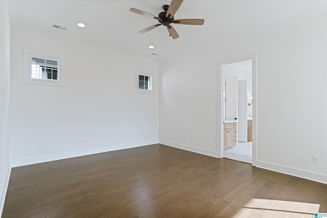 empty room with ceiling fan, baseboards, visible vents, and dark wood-style floors