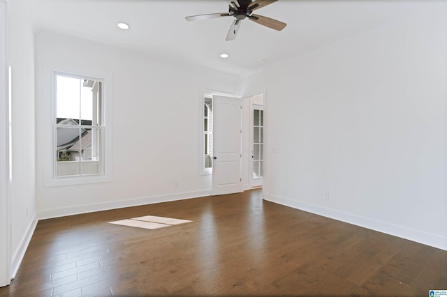 spare room with dark wood-type flooring, a ceiling fan, baseboards, and recessed lighting