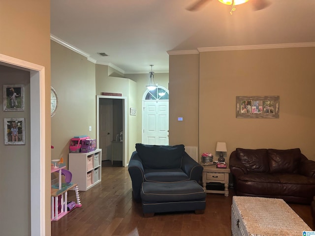 living room with ornamental molding, dark wood-type flooring, and ceiling fan