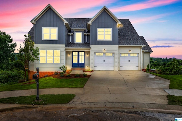 view of front of property featuring a yard, concrete driveway, a shingled roof, and board and batten siding