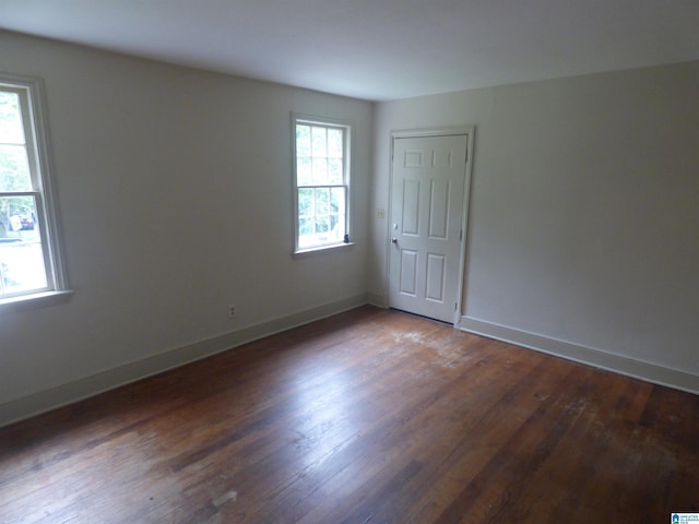 unfurnished room with wood-type flooring