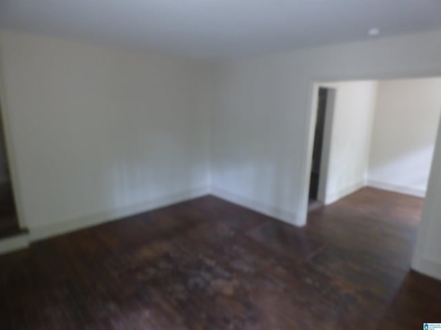 empty room with dark wood-type flooring