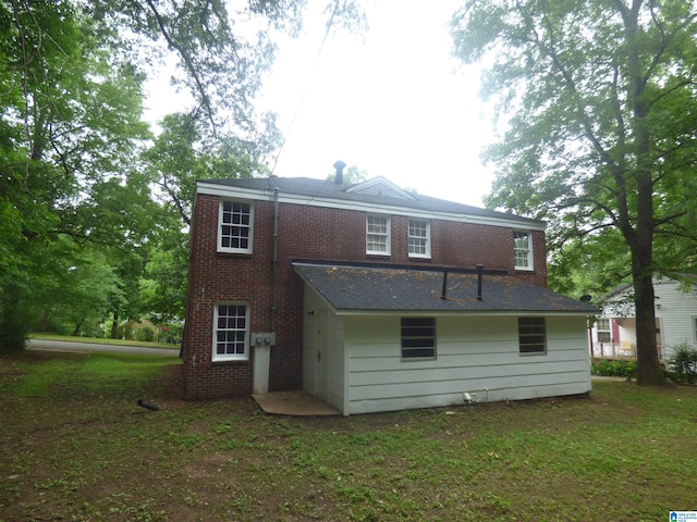 rear view of property with a lawn