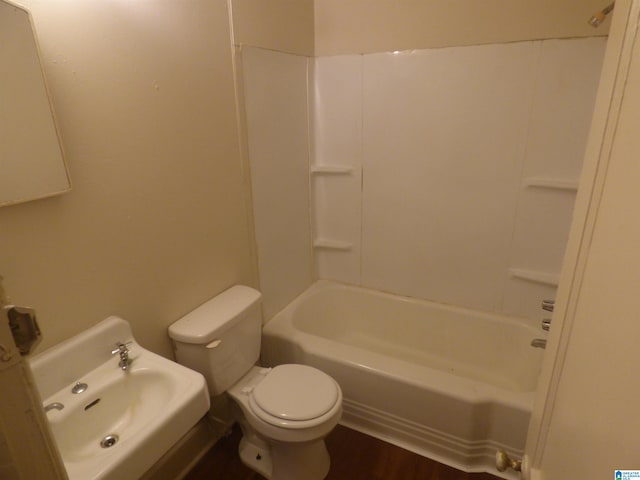 full bathroom featuring bathtub / shower combination, sink, hardwood / wood-style flooring, and toilet