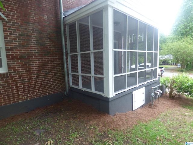 view of side of home featuring a sunroom