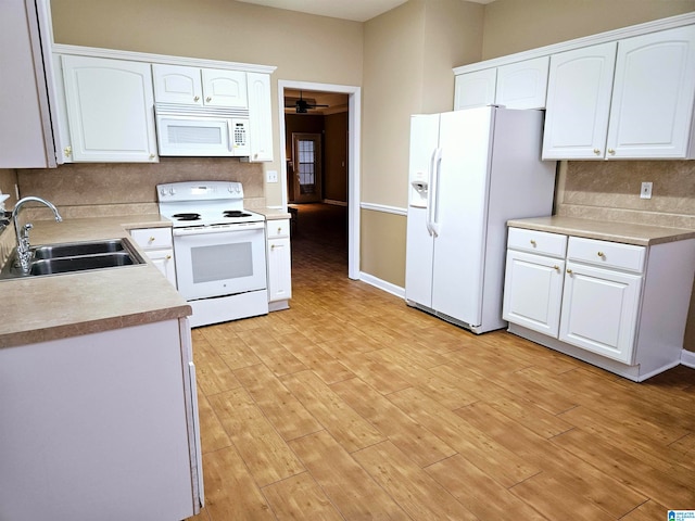 kitchen featuring sink, light hardwood / wood-style floors, white cabinets, and white appliances