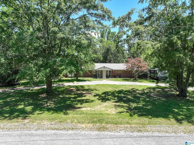 view of front of property with driveway and a front lawn