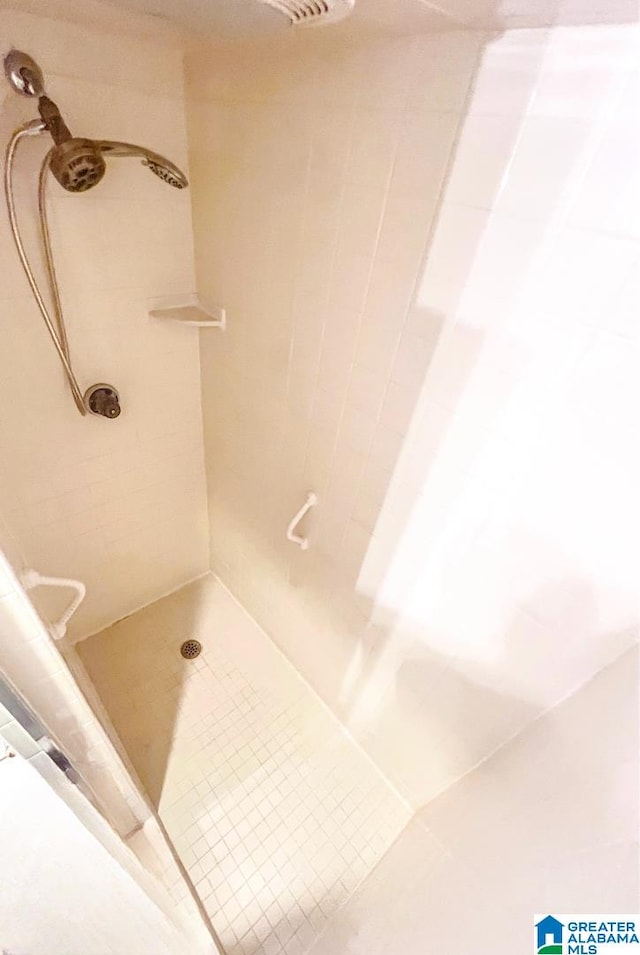 bathroom with tiled shower