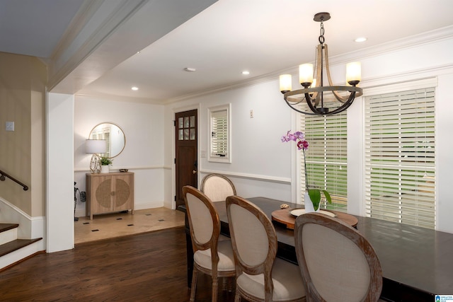 dining area featuring a notable chandelier, dark hardwood / wood-style floors, and crown molding