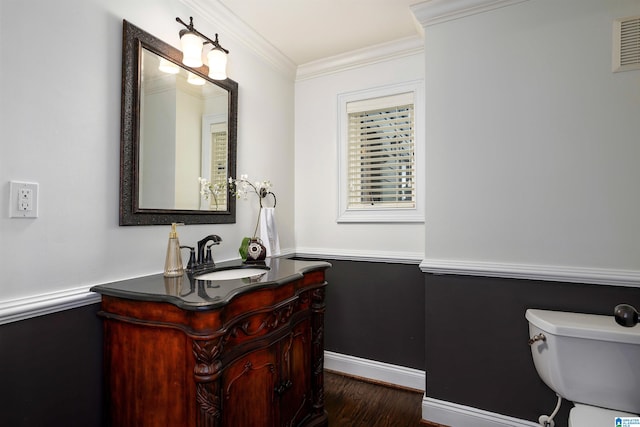 bathroom with crown molding, vanity, toilet, and hardwood / wood-style floors