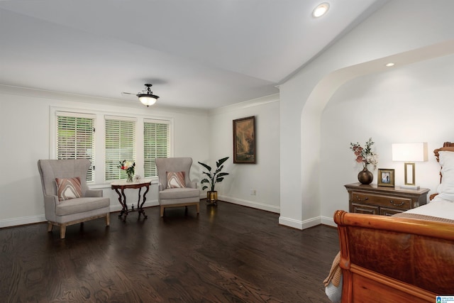 sitting room featuring dark hardwood / wood-style flooring, crown molding, and vaulted ceiling