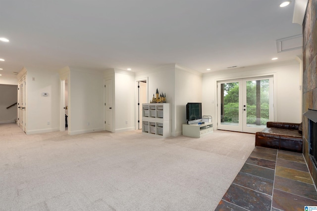 carpeted living room featuring ornamental molding and french doors