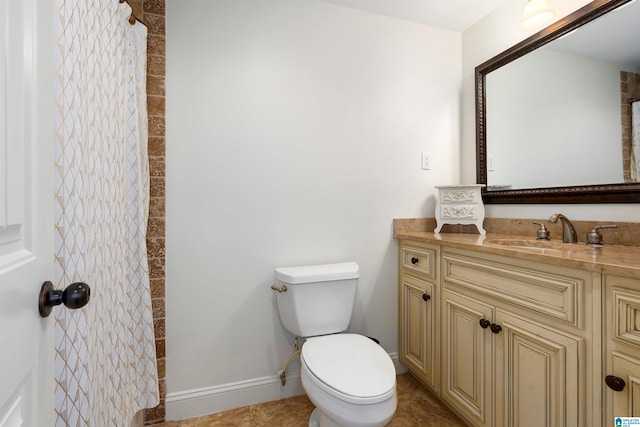 bathroom featuring vanity, toilet, and tile floors